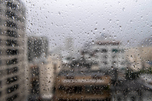 istock window glass with raindrops showing blurred city in the background 1978467265