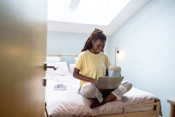 istock Young woman relaxing in the morning and using a laptop 1978482471