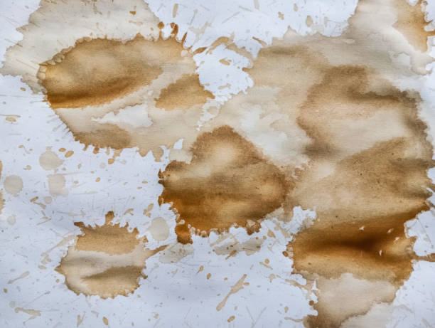 istock Abstract brown coffee grunge background. Hand made abstract artwork. Abstract brown paint wallpaper. Coffee stains, blobs and drops on white paper. 1978497001