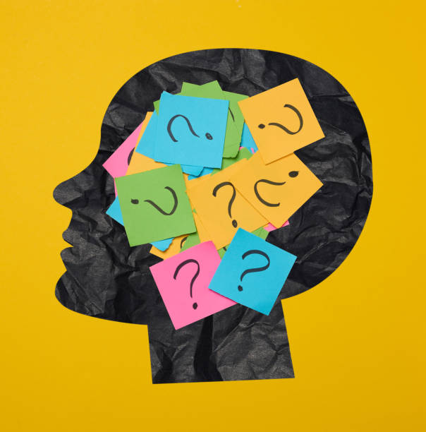istock Silhouette of a person's head with a sticker inside, featuring drawn question marks, symbolizing the concept of searching for truth. 1978536390