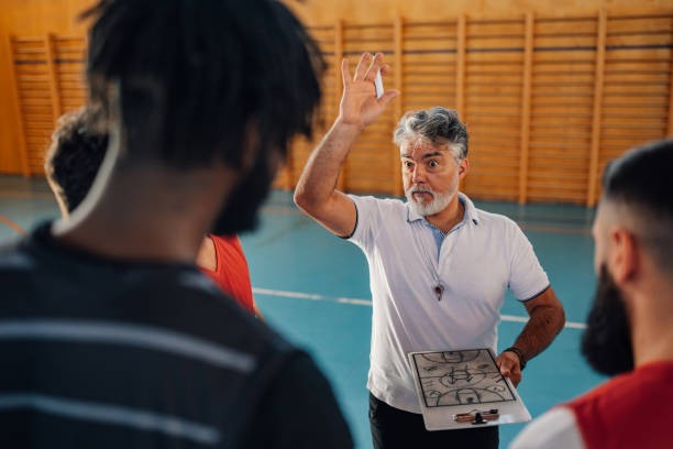 istock A senior basketball trainer discussing game plan with his team. 1978541167
