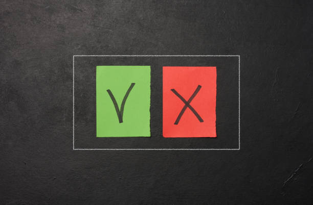 istock Two paper sheets with drawn check mark and cross symbols, representing the concept of error and correction 1978542749