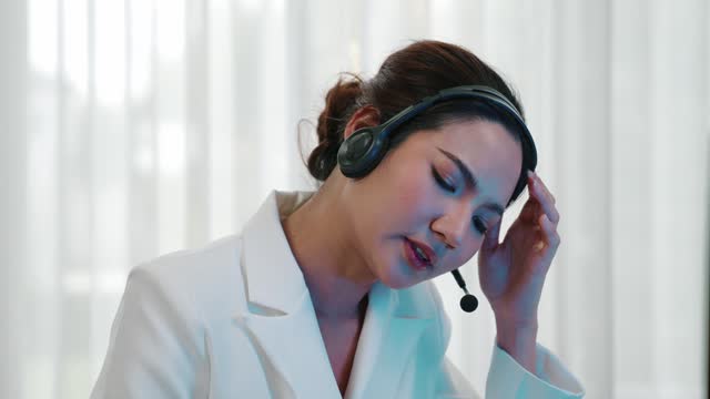 Businesswoman wearing headset working in vivancy office