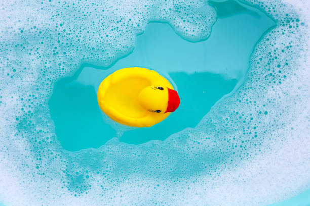 istock Yellow duck rubber toy with foam bubbles in blue basin 1978565595