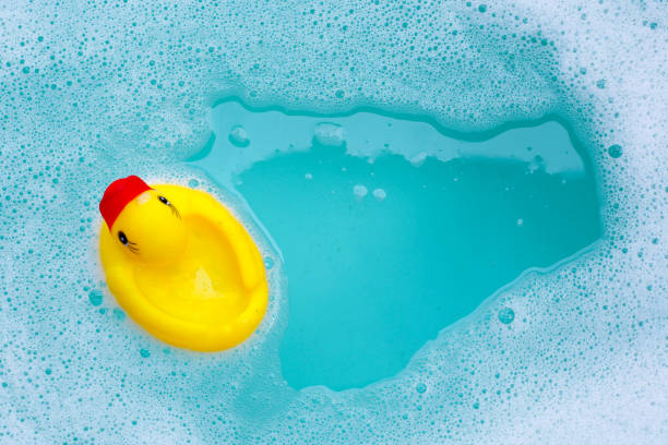 istock Yellow duck rubber toy with foam bubbles in blue basin 1978565605
