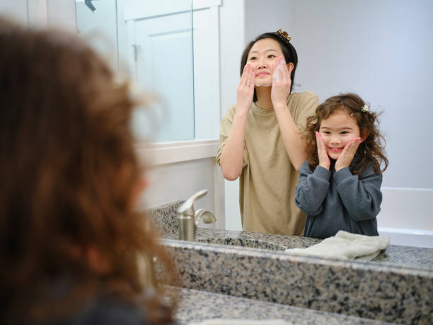 istock Mother and Daughter Washing Faces 1978576985