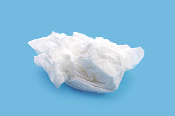 istock Crumpled tissue paper. Facial tissue on blue background. 1978584710