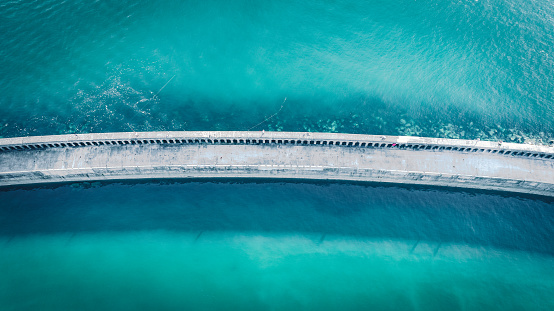 Aerial view of stone bridge connecting land and lighthouse by Newhaven port, East Sussex, UK
