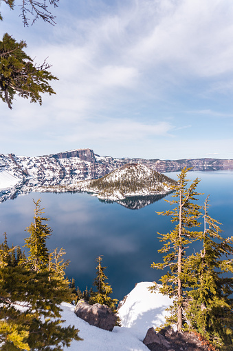 View of the mountain range and crater lake national park with snow and blue lake