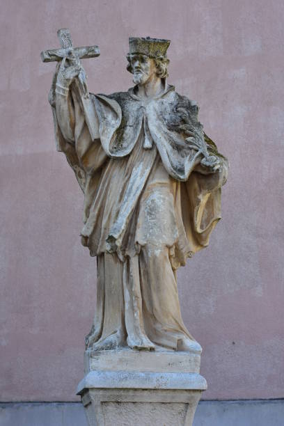istock Statue Of Saint Holding Crucifix 1978616087