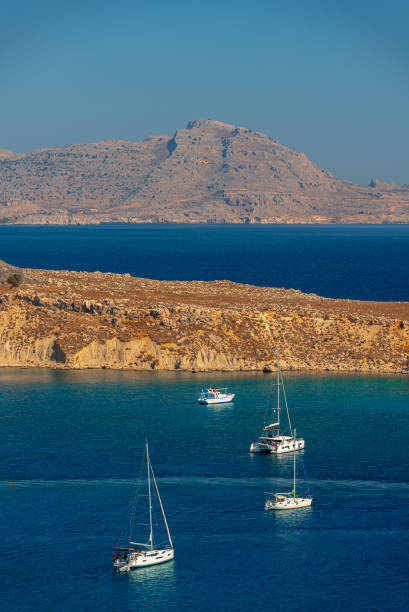 Yachts are moored in the bay.