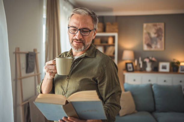 istock A mature man with an educated expression and a calm demeanor is enjoying a beautiful moment by the window. 1978619212