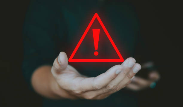 istock Alert alarm warning sign on hand, concept of emergency caution and system alarm. 1978624509