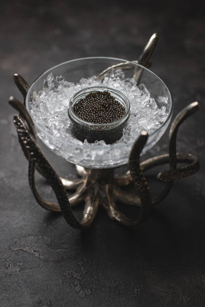 istock Black sturgeon caviar on a beautiful stand on a black textured background. Restaurant service. Delicacy. 1978627757