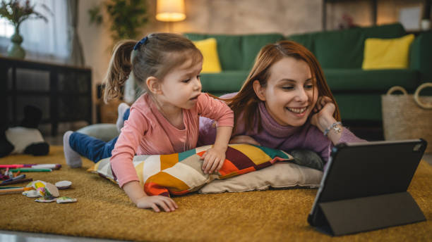 istock Mother and daughter use digital tablet to watch online video at home 1978647708