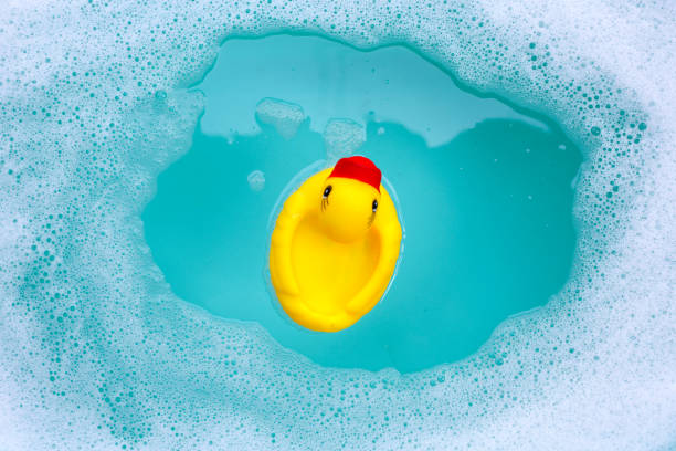 istock Yellow duck rubber toy with foam bubbles in blue basin 1978672949