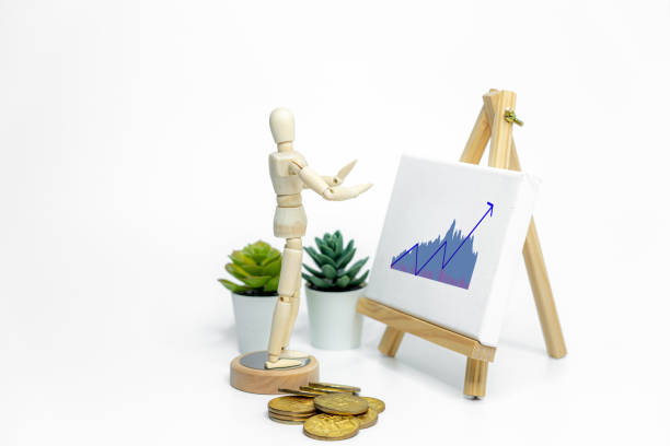 istock Mannequin drawing a graph charts on easel; isolated on white background; Business or finance concept 1978747372