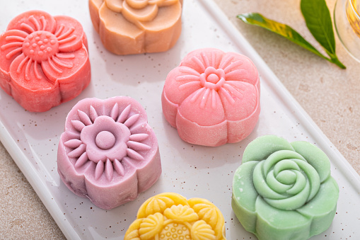 Traditional Chinese snow skin mooncakes for mid autumn festival with fruit, taro and matcha paste