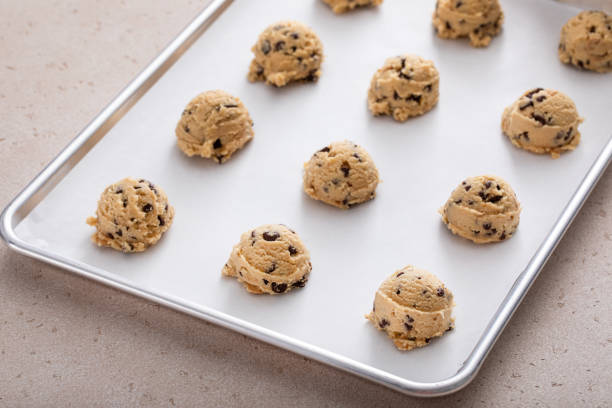istock Chocolate chip cookie dough scoopes on a cookie sheet ready to be baked 1978755121