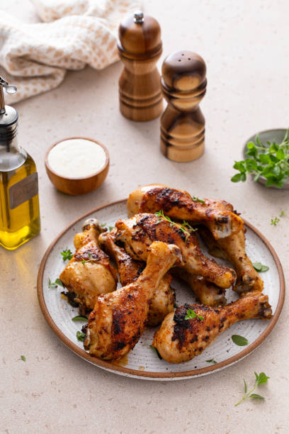 istock Roasted chicken drumsticks with garlic and herbs 1978755645