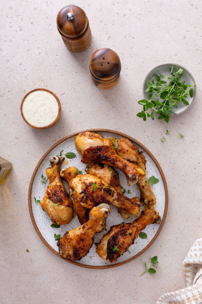 istock Roasted chicken drumsticks with garlic and herbs 1978755646