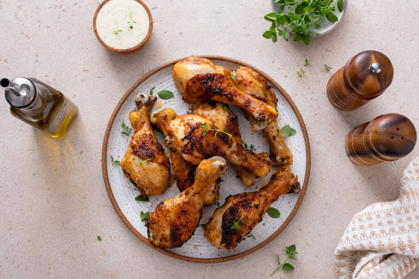 istock Roasted chicken drumsticks with garlic and herbs 1978755647