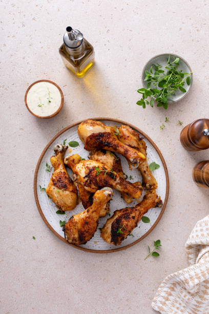 istock Roasted chicken drumsticks with garlic and herbs 1978755650