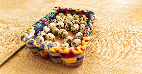 quail eggs in a basket on a rustic background
