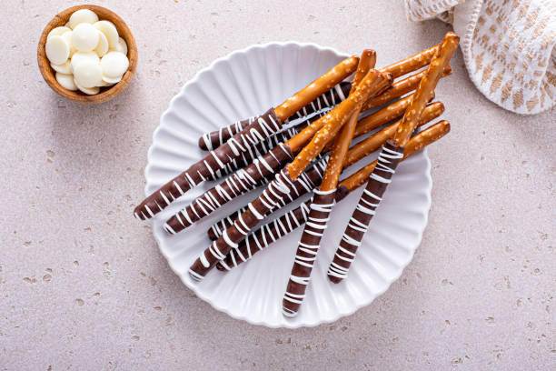 Chocolate dipped pretzel rods on a plate