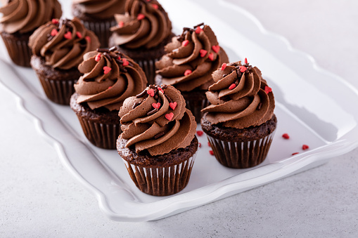 Dark chocolate cupcakes with chocolate ganache frosting and chocolate sprinkles, homemade sweet treat for Valentines Day