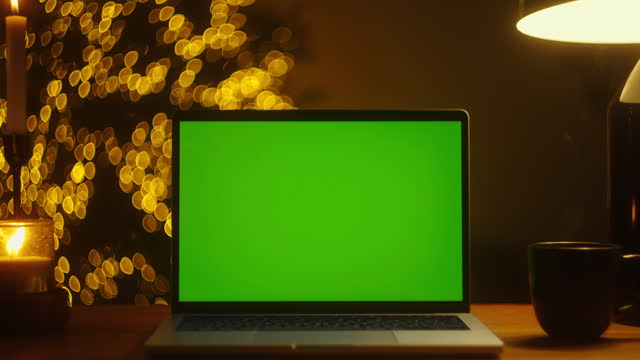 Magical Stock Footage: Dive into the Holiday Atmosphere with a Dark Room, Green Screen Laptop, and Christmas Tree