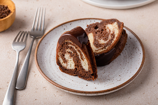 Marbled bundt cake sliced on a plate, chocolate and vanilla cake