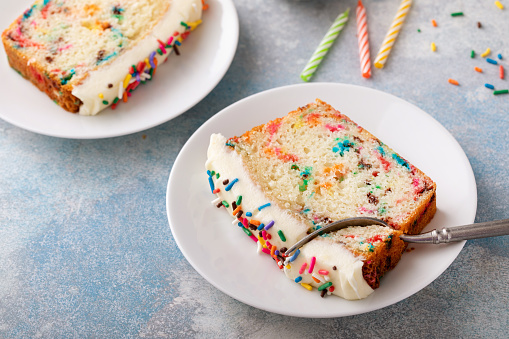Birthday cake loaf cake or funfetti quick bread with sprinkles and buttercream frosting