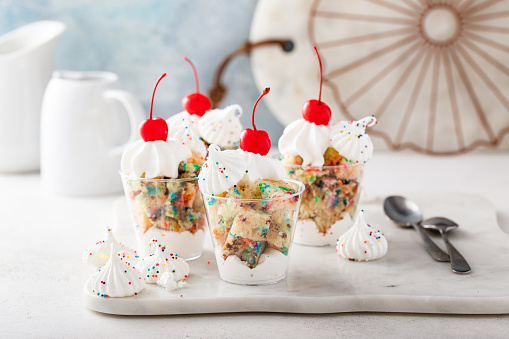 Funfetti parfait with whipped cream and a cherry on top