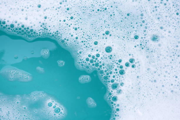 istock Detergent foam bubble on water. Blue background, Soap sud 1978784442