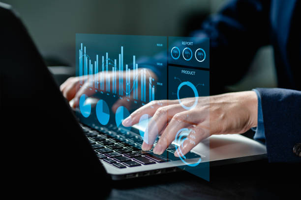 istock Businesswomen analyze chart data business on a visual screen dashboard laptop, technology devices and screens visible in the background, financial planning, market research, and the stock market. 1978811634