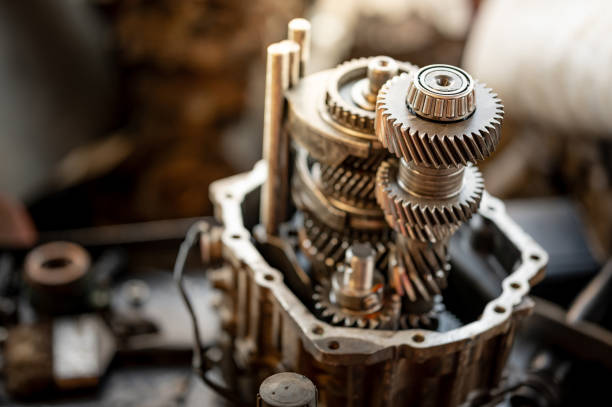 Disassembled car automatic transmission gear part or gearbox on workbench in auto repair shop. Fix and maintenance vehicle part service in the garage. Mechanical engineering and automotive industry