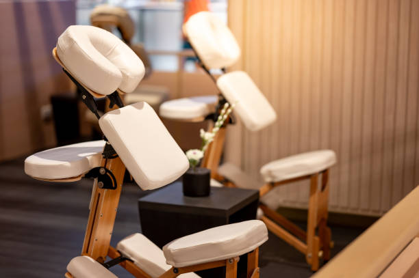 istock Portable adjustable massage chair in a cozy spa 1978836826