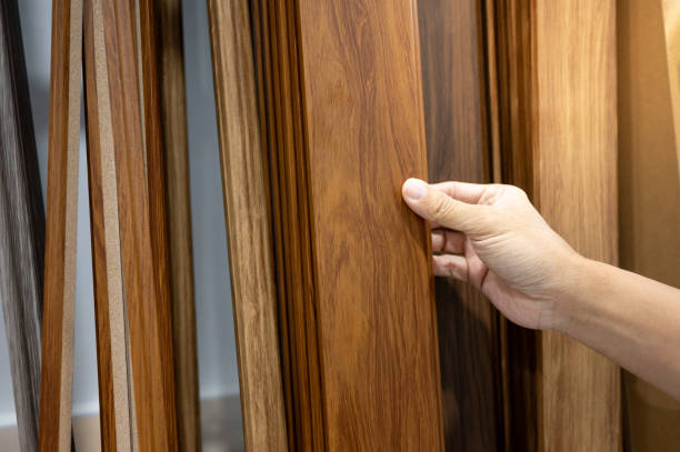 istock Hand picking sample of wood plank material in home design store 1978837930