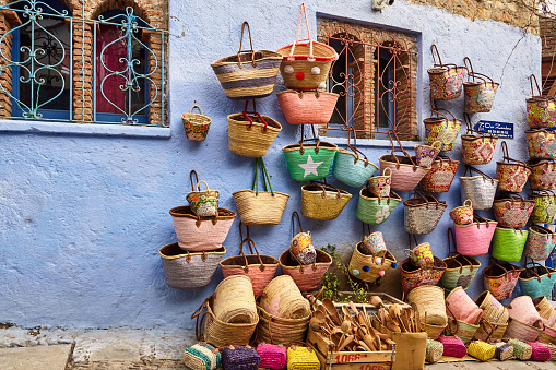 Street store with colourful handmade baskets in Chefchaouen, Morocco, North Africa.