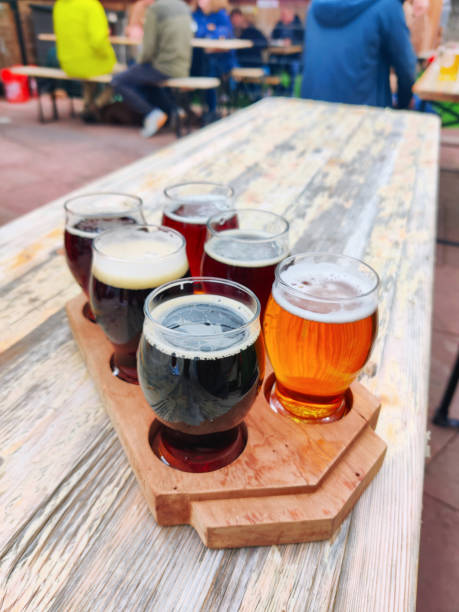 istock Beer samples set on beer garden outside restaurant table drink background texture close up photo with copy space. Biergarten, brewery, pub, bar or taproom. 1978843936