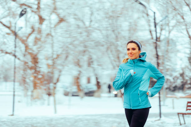 istock Active Woman Running During Winter in a Park 1978855051