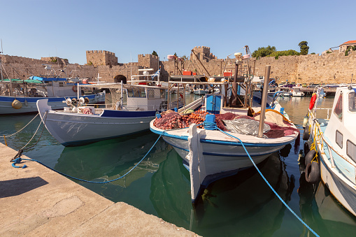 Scenic view of the old Mandraki harbor with fishing boats on a sunny day. Rhodes. Greece.