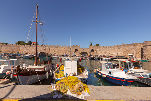 Scenic view of the old Mandraki harbor with fishing boats on a sunny day. Rhodes. Greece.
