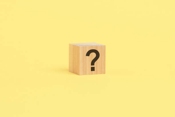 istock wooden toy cube with a question mark viewed high angle on a yelllow background with copy space 1978855829