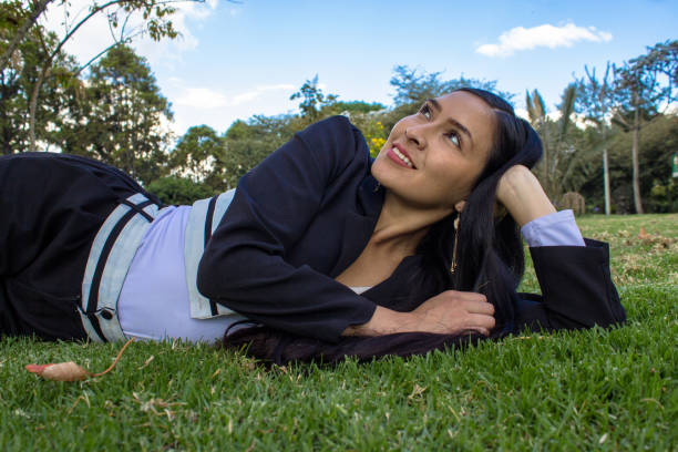 Beautiful young woman posing in a public park