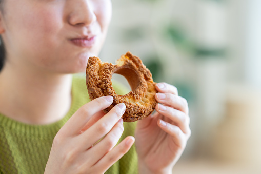 Young woman eating a pretzel