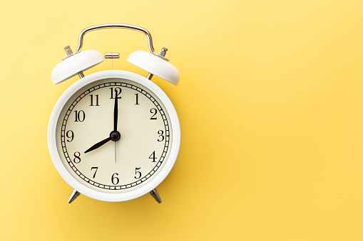 Alarm clock on a yellow background.