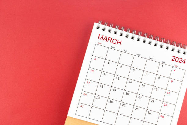 istock March 2024 desk calendar on red background. 1978927452