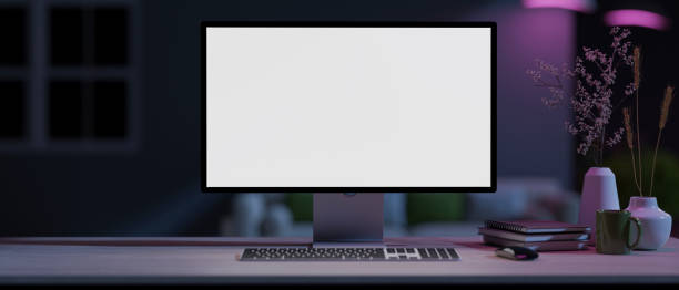 istock A modern home office with a white-screen computer mockup on a table with neon lights. 1978942250